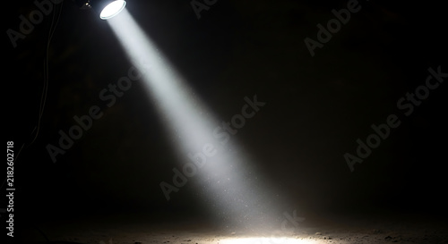 Bright spotlight beam on dark background