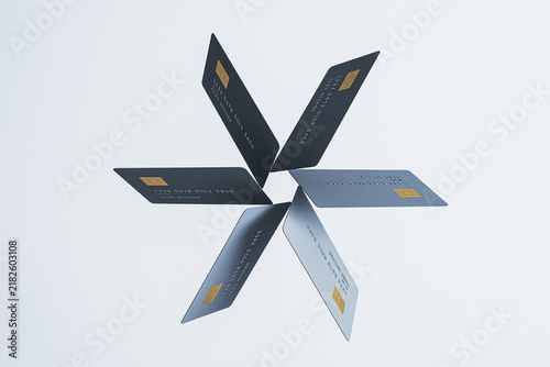 Quadro su tela Floating credit and debit cards arranged in a radial banking pattern for digital payment technology and business finance concepts