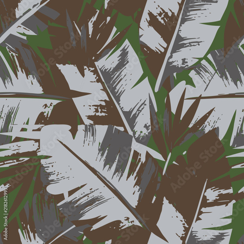 Abstract botanical camouflage seamless pattern with grunge brush stroke palm banana leaves for textile, fabric, and wallpaper background.