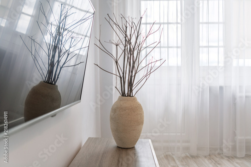 Minimal Neutral Vase With Decorative Branches On Console Table In Bright Living Room Interior