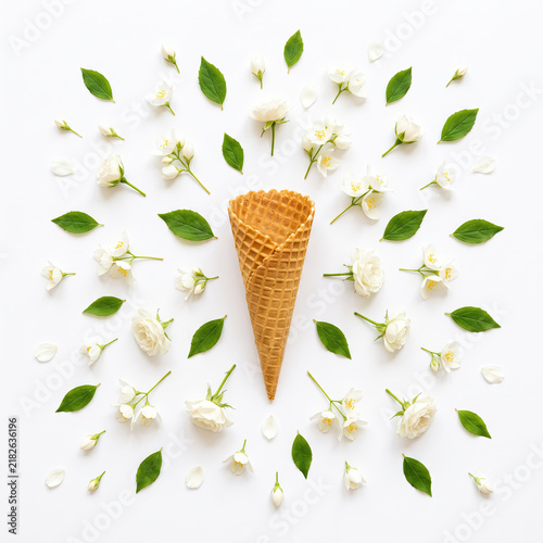 Joyful waffle cone surrounded by white flowers and green leaves