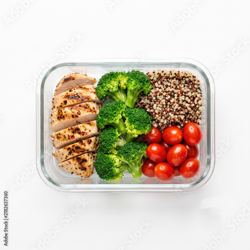 Healthy balanced meal prep with chicken, broccoli, quinoa, tomato