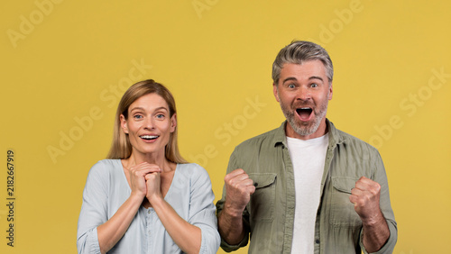 фотографія Happy Smiling Caucasian Couple In Their 30s Expressing Joy And Excitement With Fists Pumped In Air