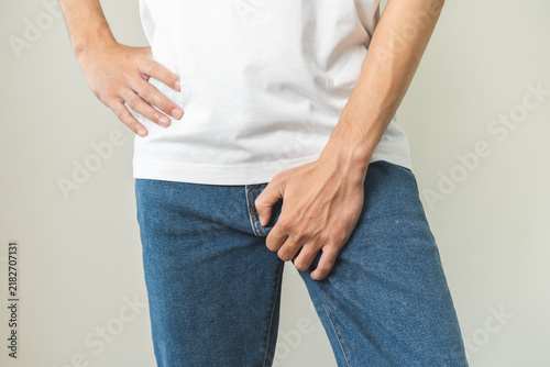 Obraz na plátně Closeup annoying itch asian man with an itchy his jock and butt, male scratching crotch with his hand, itching groin, male suffering body problem