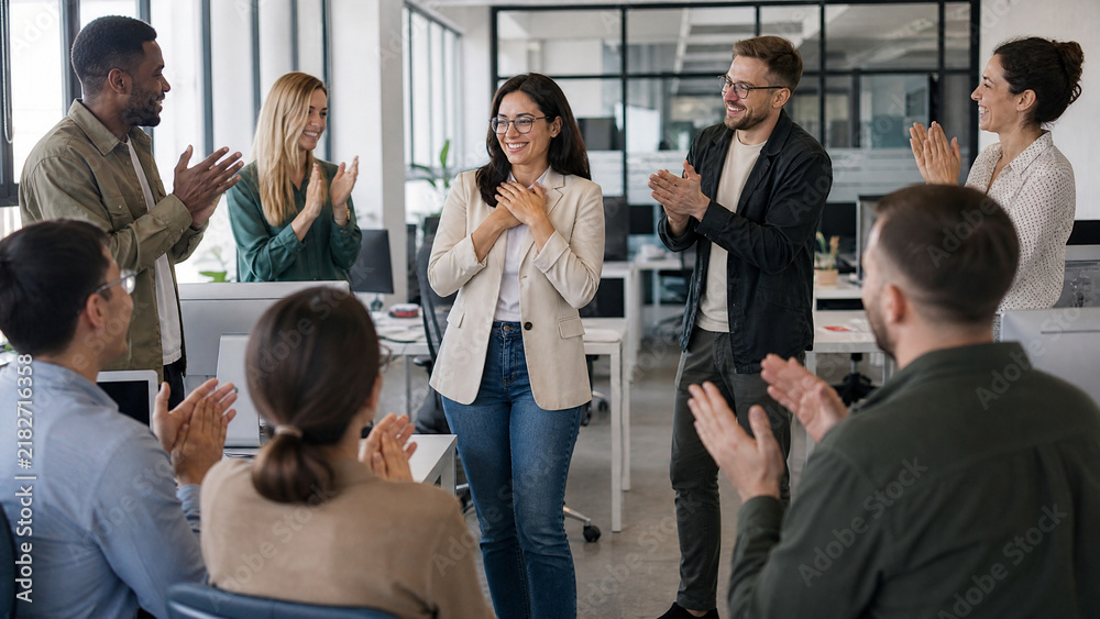 Obraz premium Diverse business team applauding female colleague in office, happy coworkers celebrating success, professional recognition and corporate achievement