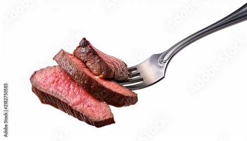 slices of beef steak on vintage fork isolated on white background or white background