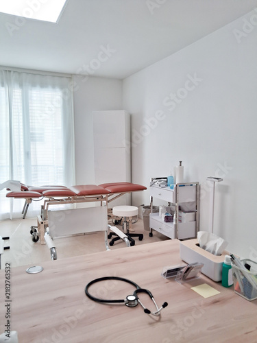 Obraz na plátně Doctor view of medical cabinet with stethoscope on foreground and Stretcher in the background
