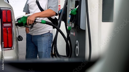 Driver refueling car at gas station