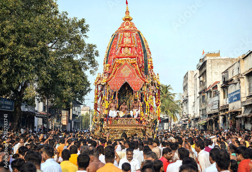 Colorful Religious Procession Featuring Elaborate Temple Chariot Amidst Large Crowd Celebration