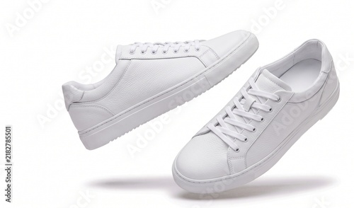 Pair of white leather sneakers isolated on white background for fashion and casual style.