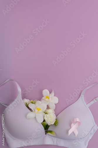 Pink ribbon on bra with flowers for breast cancer awareness
