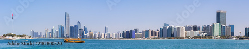 Abu Dhabi skyline with skyscrapers and Dhow boat banner panoramic view at sea in Abu Dhabi, United Arab Emirates