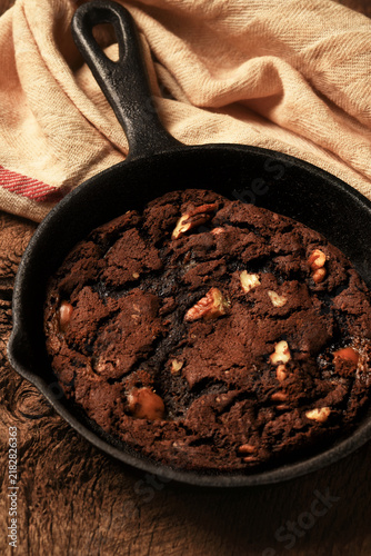 Skillet Brownie Cookie Still Life. A Chocolate Chip Pecan Brownie Cookie in a cast iron skillet.