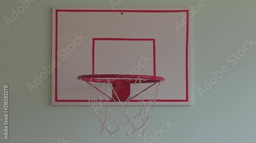 Unseen player attempting to score in a miniature basketball hoop. The ball bounces off the rim, symbolizing a miss, failure, or bad luck
