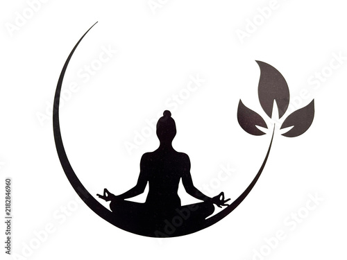 Black silhouette of a man in the lotus position against the background of a crescent moon. Close-up.