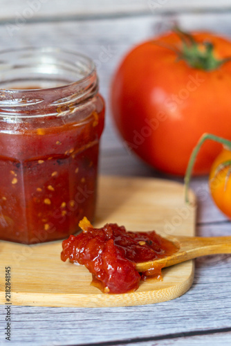 Homemade Tomato Jam in Glass Jar with Fresh Tomatoes