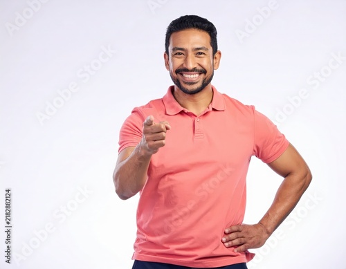 Middle aged Man in Salmon Polo Shirt Pointing Forward with Happy Smile