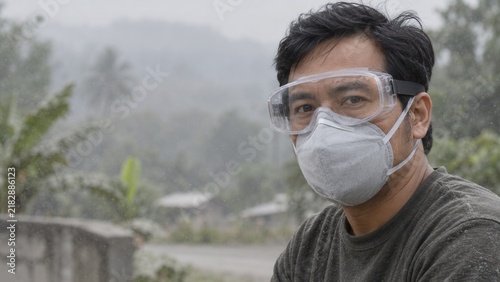 Southeast Asian Adult Wearing Respirator During Volcanic Ashfall