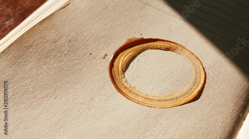 Close-up of a beige-colored surface with a circular indentation in the center. the indentation appears to be made of a smooth, textured material, possibly paper or fabric.