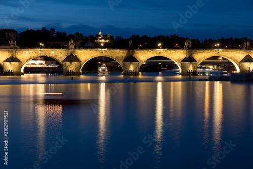Konstfotografi Charles Bridge over the Vltava River in Prague at night with lights reflecting o