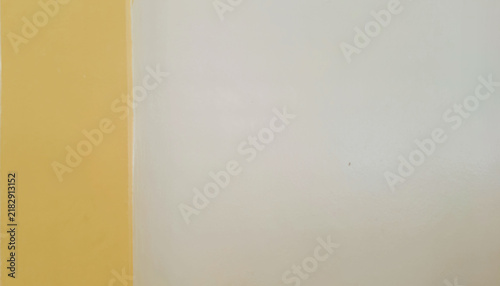 Bild auf Leinwand Minimalist two-tone background with a vertical split of warm mustard yellow and cream