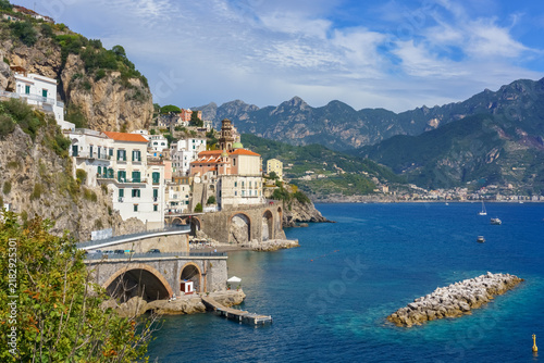 Scenic view of Atrani village at Amalfi coast in Italy. Beautiful coastal landscape of Atrani town with historic church and stone arches over blue sea water.