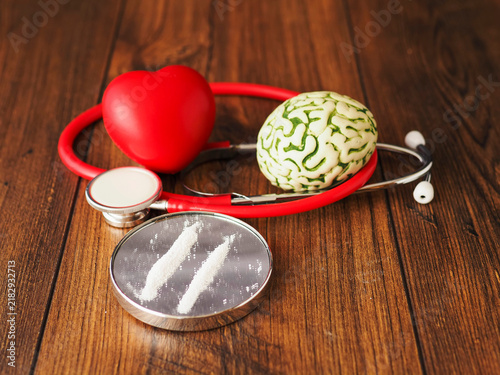Картината върху платно Stethoscope rests beside brain model and tow line of drugs on small mirror on wooden surface
