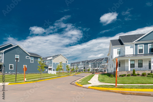 Modern townhomes line a curving suburban residential street in Leesburg, Virginia.