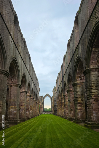 Fotografie Fountains Abbey is a ruined Cistercian monastery near Ripon in North Yorkshire, England