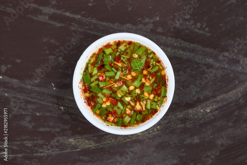 Thai spicy dried chili dipping sauce in a small white ceramic bowl