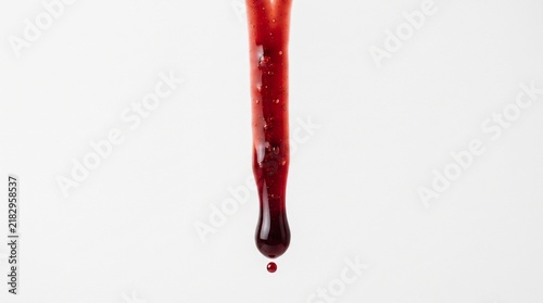 Dripping blood isolated on white background. Flowing bloody stains, splashes and drops. Trail and drips red blood close up