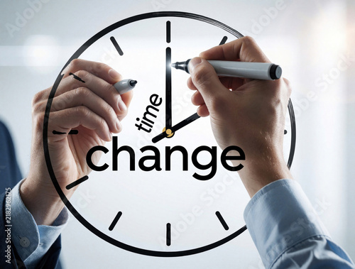 Businessman hands write time for change on transparent glass clock. Person uses marker to draw message about urgency  transformation. Concept of management  deadline  moving forward in business