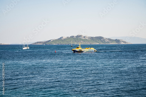 Photography high-speed yellow-blue ship near the island of Aegina