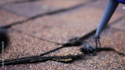  Man uses Caulk Gun to Insert Tar to repair roof