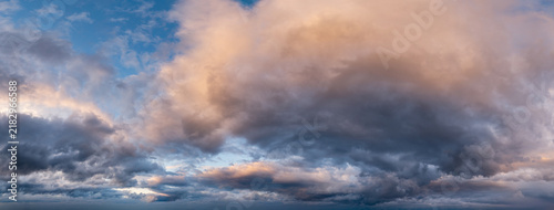 Bild auf Leinwand Dramatic Sunset Clouds Over Coastal Sky Panorama With Warm Light in BC, Canada