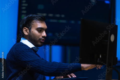 Canvas Print A male technology consultant in a tailored dark jacket and open collar moves qui