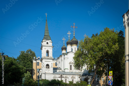 фотографія Moscow, Russia, 1 September 2026,  Church of Saint Vladimir in Staryye Sady with its white belfry and dark domes against a blue sky in Moscow, Russia
