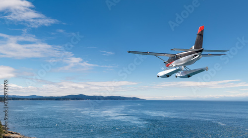 Obraz na plátně Seaplane Floatplane Flying Over Coastal Ocean and Islands, Scenic Aviation Fligh