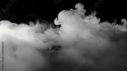 Thick white smoke flowing on black.
