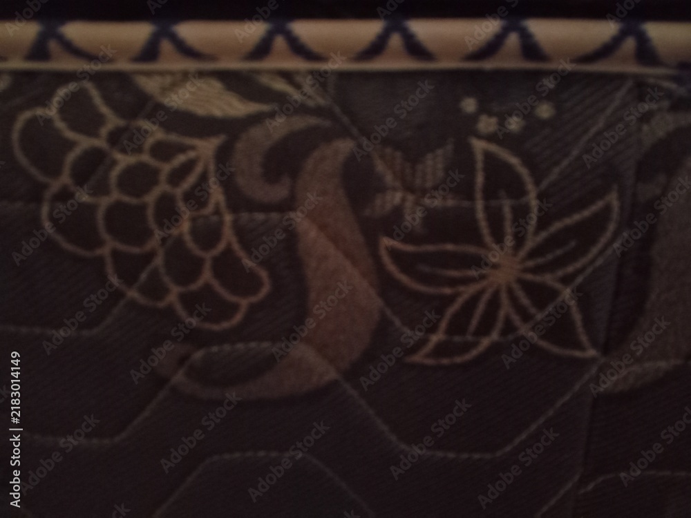 Obraz premium Dark brown floral pattern quilted fabric texture close up for background design template.