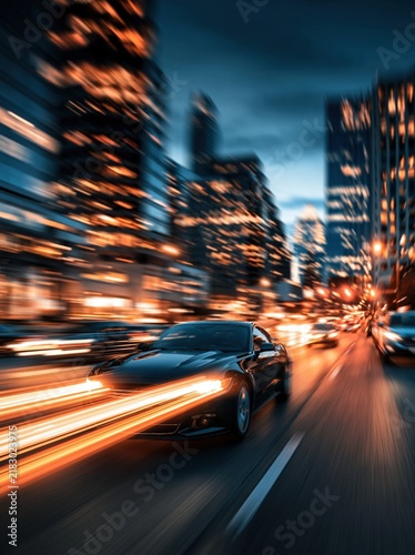 Black sports car speeding through city at night