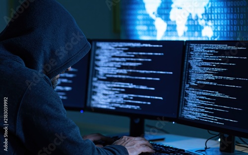 Obraz na płótnie Hacker in a hoodie using computer screens for cybersecurity programming and digital network data security crime