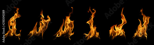 Collection of multiple fire flame plumes and burning fire tongues isolated on black background. Dynamic bonfire spark overlay for cinematic special effects and energy design assets.