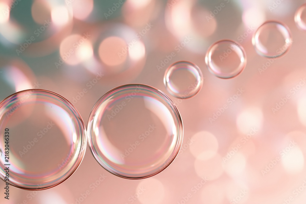 Obraz premium Soap bubbles floating against soft pink bokeh background