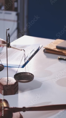 Close-up of judge gavel and scales of justice on lawyer desk.