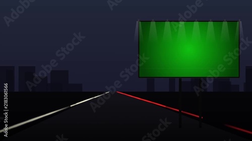 Illuminated Green Screen Billboard on Night Highway with City Skyline and Traffic Light Trails