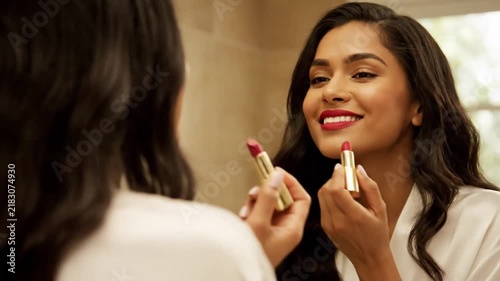Beautiful Woman Applying Lipstick in Front of Mirror. 4K Video