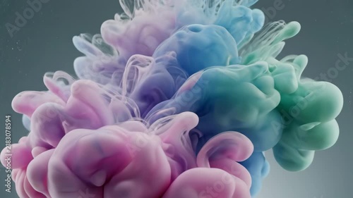 Pink and blue ink clouds swirling in clear water, abstract liquid color explosion background.