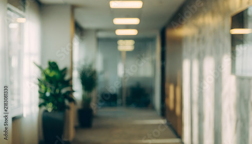 Blurred Modern Office Corridor with Plants and Soft Lighting