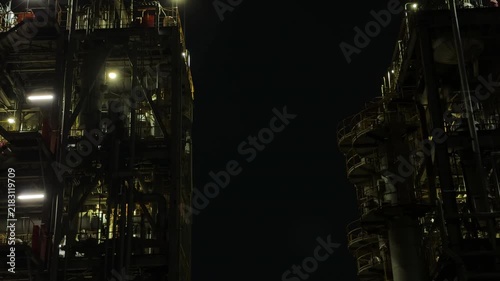 Twin Industrial Plant Structures Framing a Dark Gap at Night in Chidoricho, Kawasaki